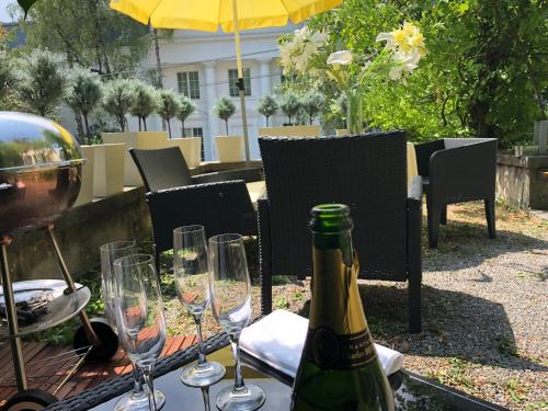 a bottle of wine sitting on a table with wine glasses at Garden Studio Apartment Zürichberg in Zürich