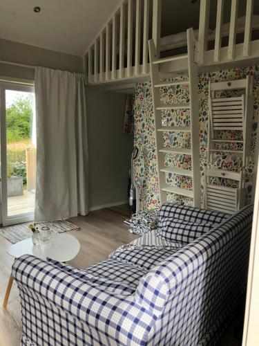 a living room with a checkered couch and a table at Annelund in Varberg