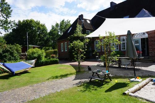 a garden with a hammock and a house at Bahnhof Vaale Kehrwieder in Vaale