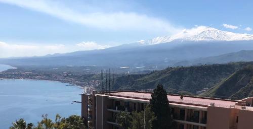 a view of a mountain and a body of water at Hotel Elios Tao in Taormina