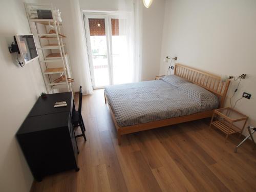 A bed or beds in a room at Bella Vita Rooms