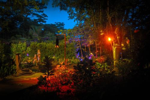 a garden at night with flowers and lights at Las Brisas del Sur in Ojochal