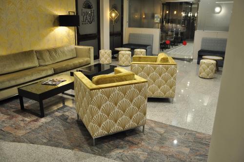 a lobby with two couches and a table and chairs at Hotel & Spa Real Jaca in Jaca