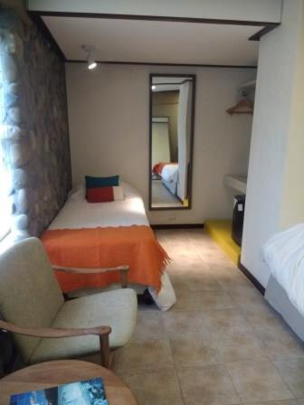 Una cama o camas en una habitación de Hotel ACA El Calafate