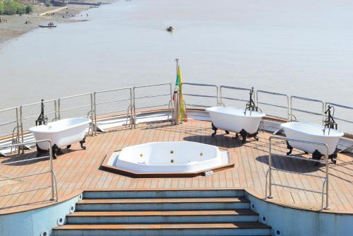 a boat with three bath tubs on the deck at Vintage Luxury Yacht Hotel in Yangon