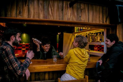 a group of people sitting at a bar at RocaMar Hostel Boutique in Punta del Este