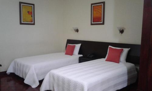Ένα ή περισσότερα κρεβάτια σε δωμάτιο στο Hotel Villa Tournon
