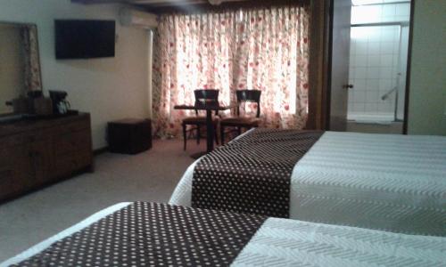 Ένα ή περισσότερα κρεβάτια σε δωμάτιο στο Hotel Villa Tournon