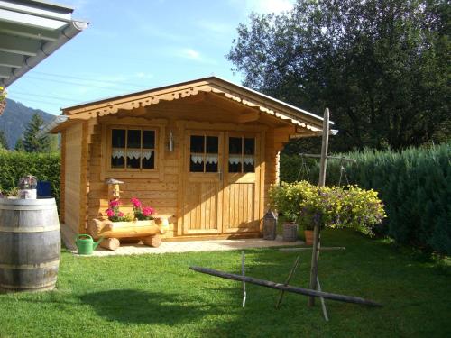 a small wooden shed with a bench in a yard at Ferienhaus Antoinette in Biberwier