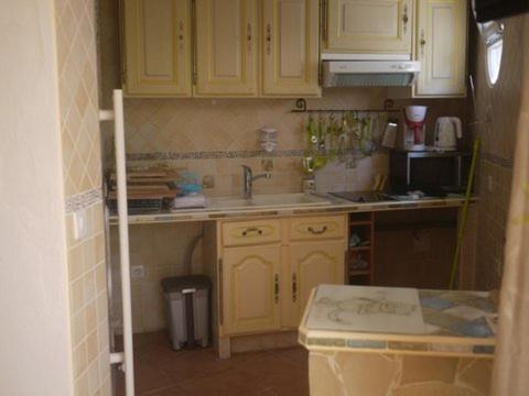 a kitchen with yellow cabinets and a sink at Appartement Charme et Coeur in Villefranche-sur-Mer