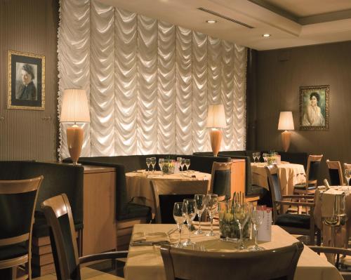 a dining room with tables and chairs and a window at Ramada by Wyndham Naples in Naples