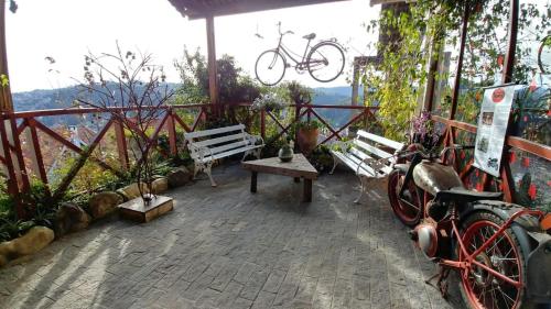 a patio with benches and a bike parked on it at Pousada dos Esquilos in Campos do Jordão