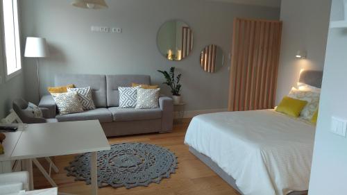 a living room with a bed and a couch at S Bento Boutique Apartment in Porto