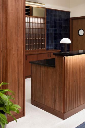 a lobby with a bar with wood paneling at Eaton DC in Washington