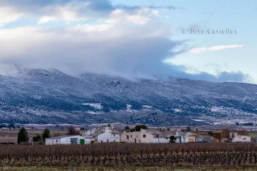 a small village with a mountain in the background at Casa Rural El Llano Quintanilla in Yecla