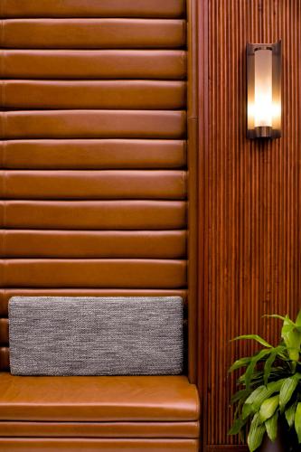 a wooden bench with a light on a wall at Eaton DC in Washington
