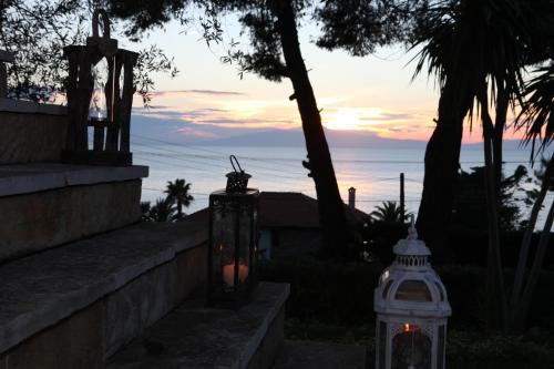 a couple of lanterns with the ocean in the background at VV Luxury Experience in Fourka