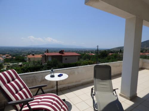 two chairs and a table on a balcony with a view at Nestos, Meer und Berge - Griechenland mal anders in Zarkadhiá
