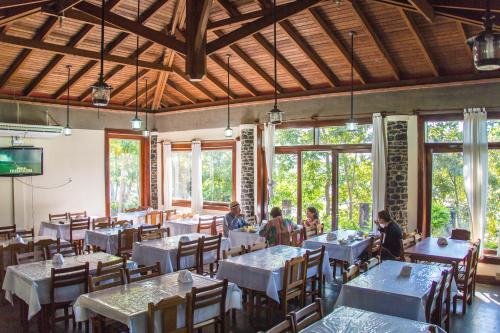 a group of people sitting at tables in a restaurant at Candeias Hotel Gold Fish in Corumbá