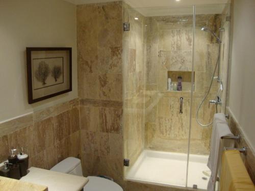 a bathroom with a shower and a toilet at Cap Cana Luxurious Marina Condo in Punta Cana