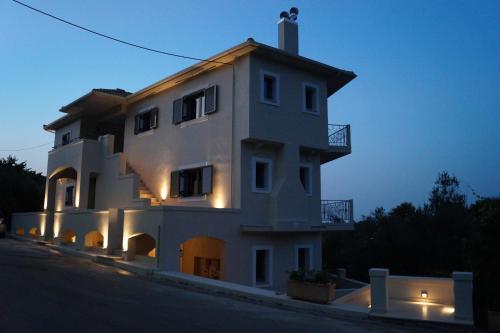 a large white building with lights on the side of it at Lagkada Suites in Kariá