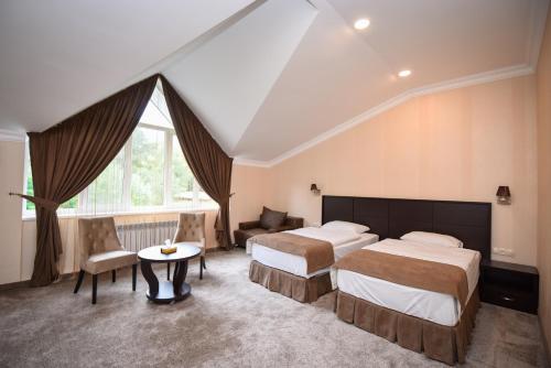 a hotel room with two beds and a table at Laguna Hotel in Vanadzor