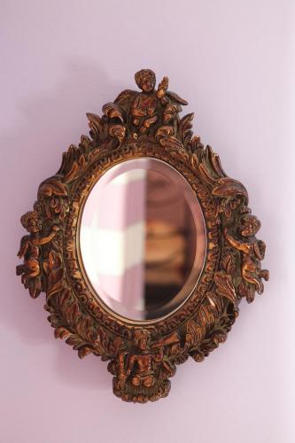 a mirror with a wooden frame on a wall at VV Luxury Experience in Fourka