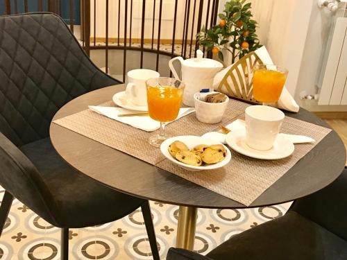 a table with a tray of food and orange juice at Casa Tita in Agrigento