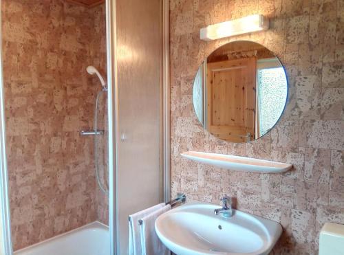 a bathroom with a sink and a shower and a mirror at Ferienwohnung Martin in Thalfang
