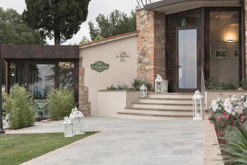 a building with a porch and stairs in front of it at Hotel Le Macine in Montaione