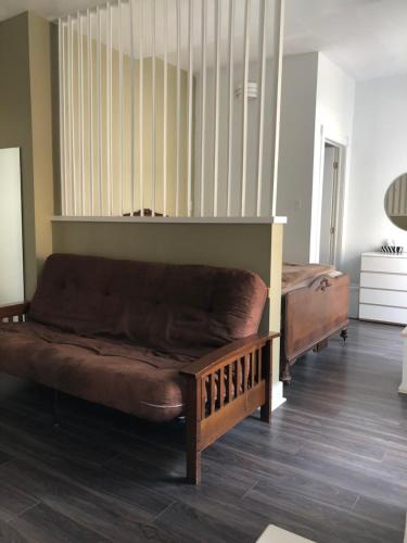 a couch sitting in a living room next to a bed at Auberge St-Louis in Quebec City