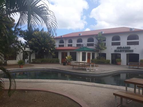 a hotel with a pool in front of a building at Grand Eastern Hotel in Labasa