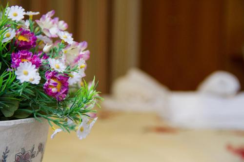 a bouquet of flowers in a vase on a table at Hotel Rodon in Paralia Katerinis