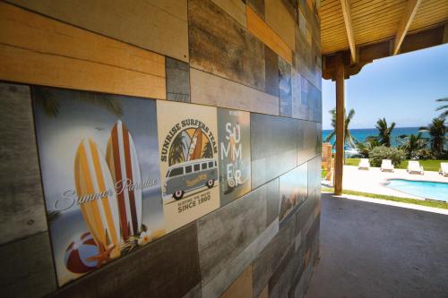 a wall with surfboards on the side of a building at Hotel El Guajataca in Quebradillas