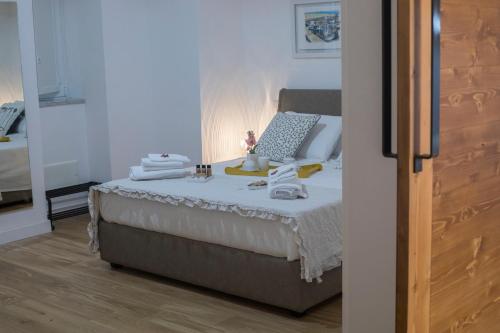 a bedroom with a bed with towels on it at La dimora del barone in Salerno