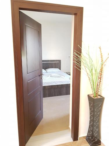 a door leading into a bedroom with a bed at Vila DINI Ksamil in Ksamil
