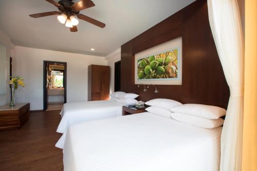 a hotel room with two beds and a ceiling fan at Krystal Grand Nuevo Vallarta in Nuevo Vallarta 