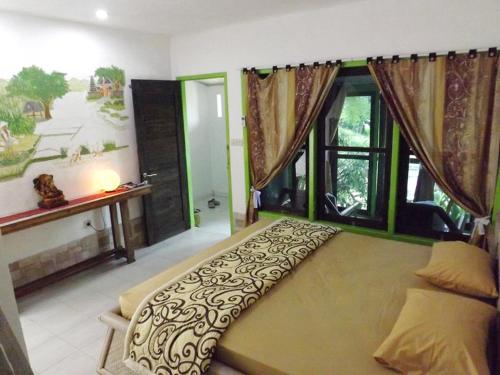 Krevet ili kreveti u jedinici u okviru objekta Uma Nandhi Ubud Natural Cottage