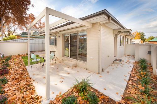 a home with a patio and a house at Central Sojourn on Wilcox in Albury