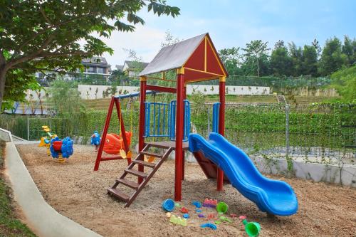 a playground with a slide and toys in the sandbox at Aston Sentul Lake Resort & Conference Center in Bogor