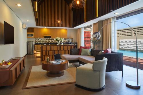 a living room with a couch and a table at Aston Sentul Lake Resort & Conference Center in Bogor