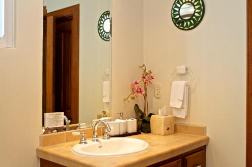 a bathroom with a sink and a mirror at Los Suenos Resort Veranda 5A by Stay in CR in Herradura