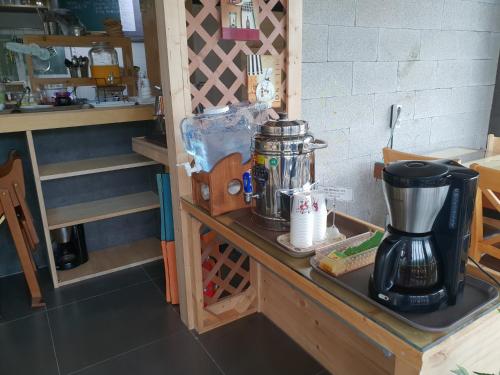 a counter in a kitchen with a coffee maker on it at White Cabin in Pyeongchang 