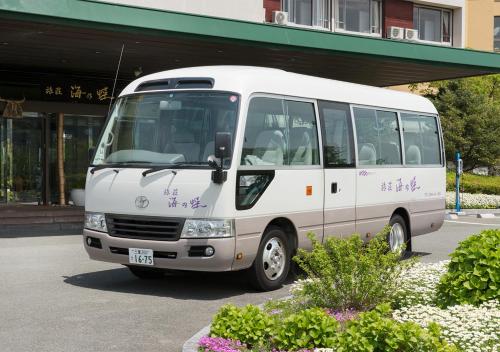 a white bus parked in front of a building at Ryoso Uminocho in Ise