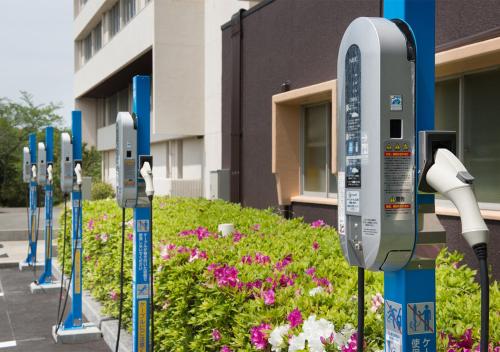 a row of parking meters in front of a building at Ryoso Uminocho in Ise