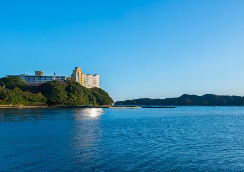 a large body of water with a building in the background at Ryoso Uminocho in Ise
