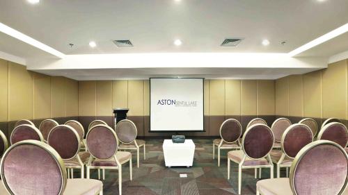 a conference room with chairs and a screen at Aston Sentul Lake Resort & Conference Center in Bogor