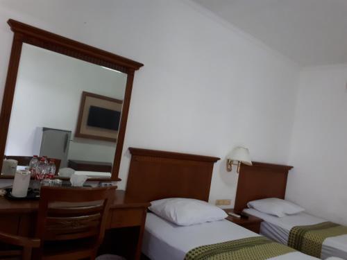 Postel nebo postele na pokoji v ubytování Semeru Park Hotel