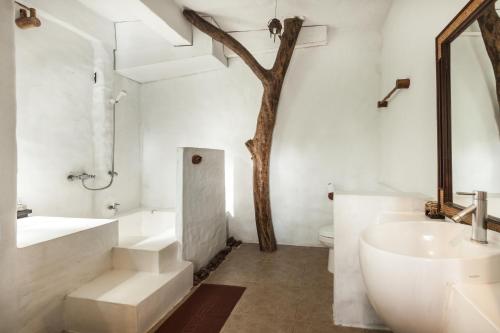 a bathroom with a sink and a bath tub and a tree at Koh Mak Cococape Resort in Ko Mak