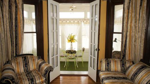 a living room with two couches and a table at A Night to Remember B & B in Niagara Falls